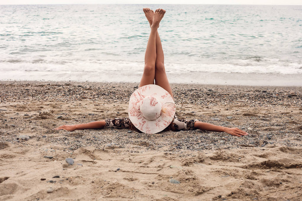 Portrait de femme gardant les jambes sur la plage
 - Photo, image