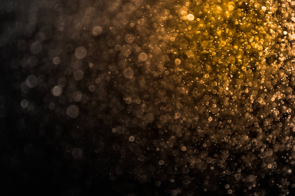 Bokeh oro abstracto y fondo negro, navidad luz dorada
 - Foto, imagen