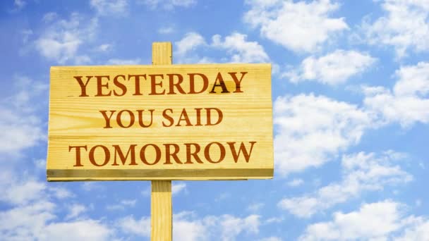 Yesterday you said tomorrow. Words on a wooden sign against time lapse clouds in the blue sky. - Footage, Video