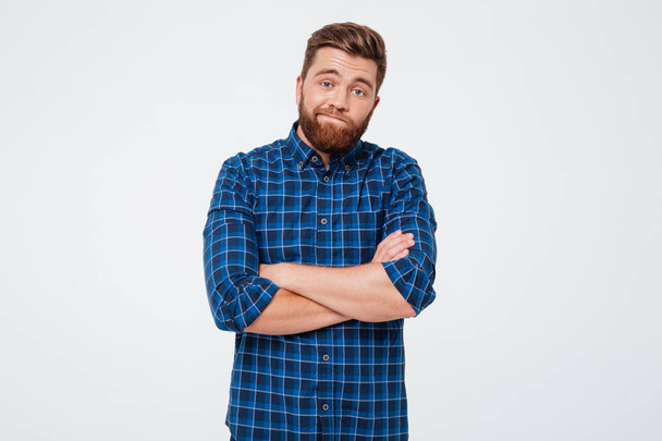 Confused frustrated bearded man standing with arms folded - Photo, image