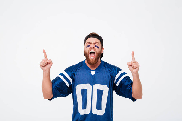 Screaming man fan in blue t-shirt standing isolated - Photo, image