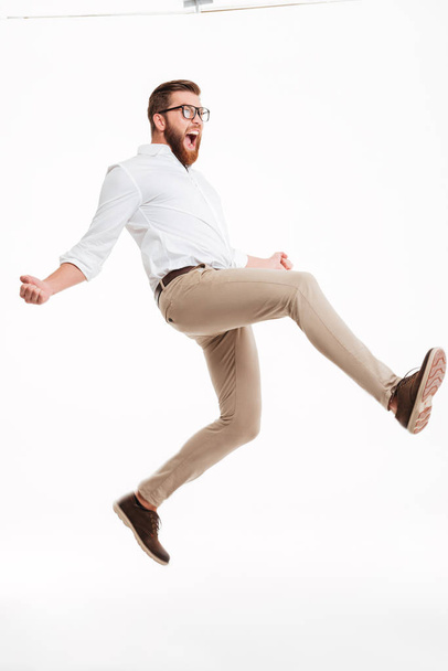 Handsome young bearded man jumping - Фото, изображение