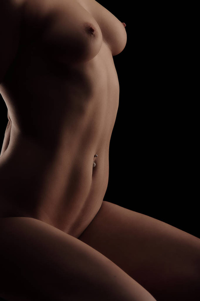 contours of naked female body on dark background. perfect natural shape isolated on black - Фото, изображение