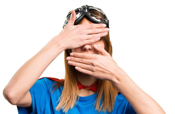 Pretty superhero girl covering her face - Photo, Image