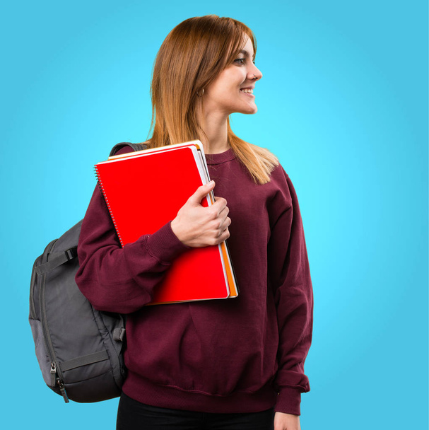 Student woman looking lateral on colorful background - Φωτογραφία, εικόνα