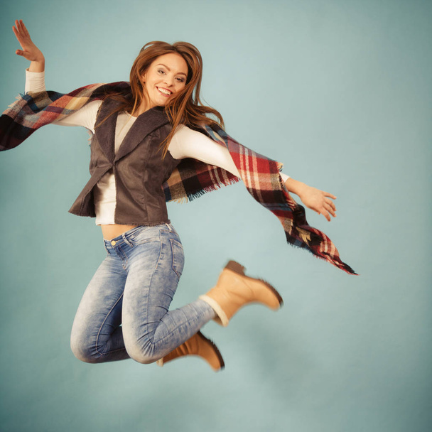 Woman fashion autumn girl jumping, flying in air on blue - Fotó, kép