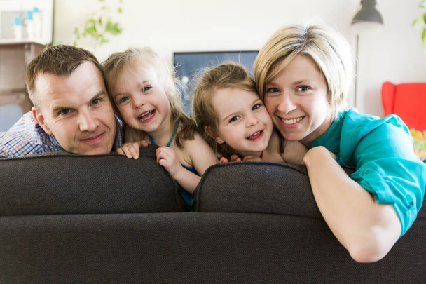 happy family with twin kids on the couch - Φωτογραφία, εικόνα