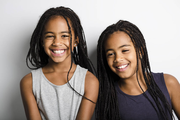 Adorable african twin little girls on studio gray background - Fotoğraf, Görsel
