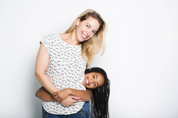 black girl with her mother, isolated on gray background - Foto, Bild