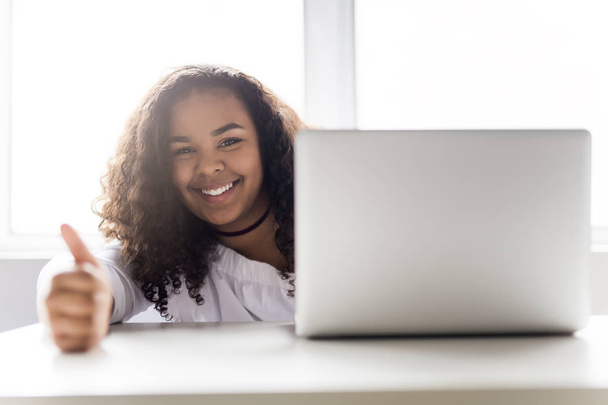 teen at desk in her office with laptop - Fotó, kép