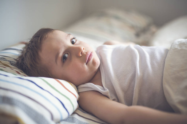 Young Boy on bed - Фото, изображение