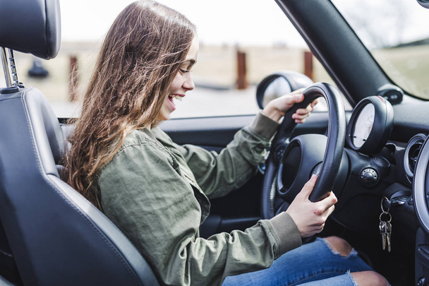 young brunette woman in new car - Photo, image
