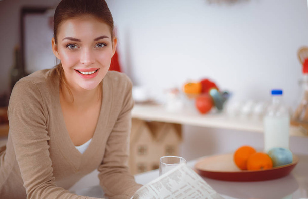 Happy young woman having healthy breakfast in kitchen - Foto, imagen