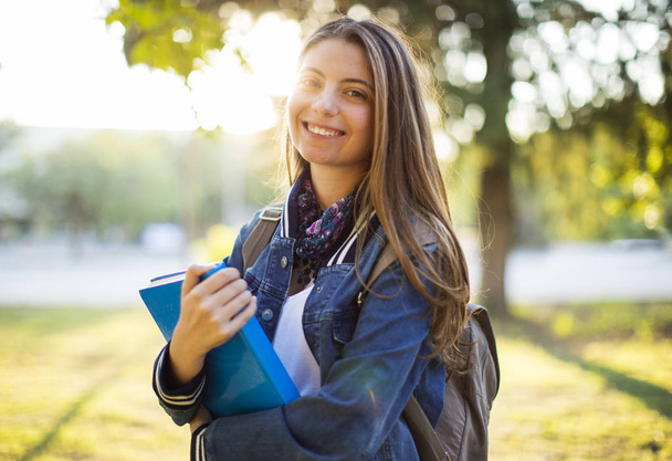 Portrait of female university student outdoors on campus - Фото, зображення