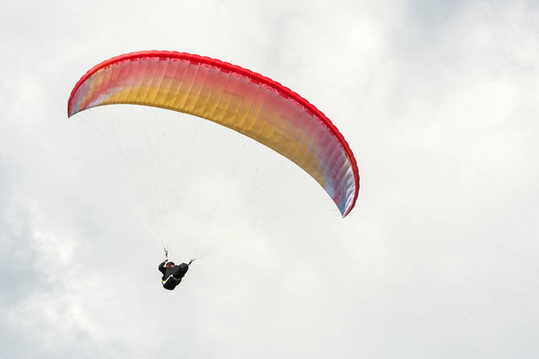 Paraglider flying in the blue sky against the background of clouds. - Photo, Image