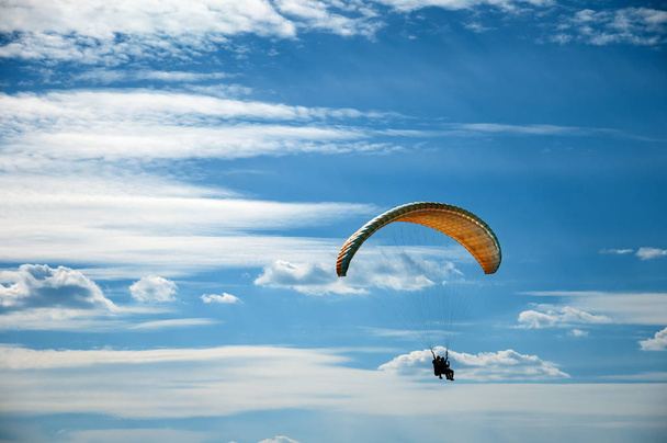 Парагвайдер летить у блакитному небі на тлі хмар
. - Фото, зображення