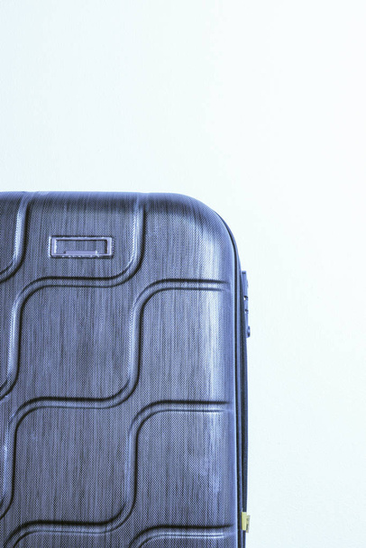 Four wheeled hard shell black suitcase - 写真・画像