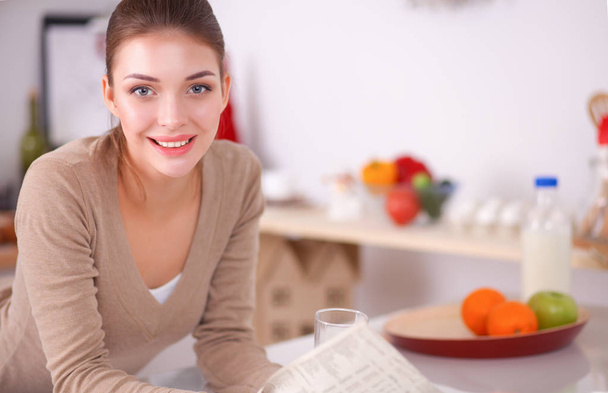 Happy young woman having healthy breakfast in kitchen - 写真・画像