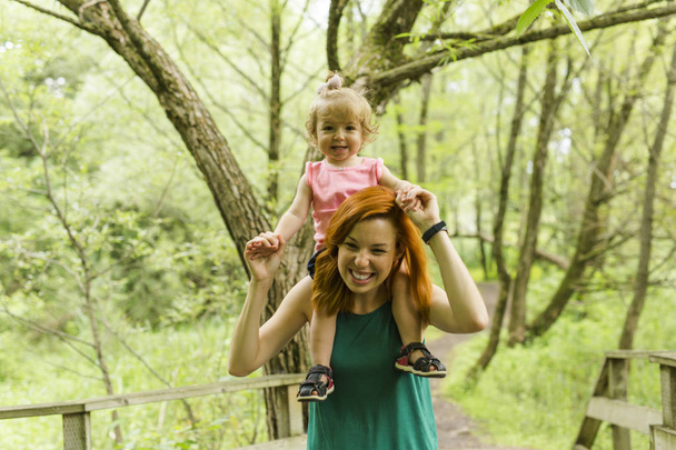 Daughter with mother on nature. - Photo, image