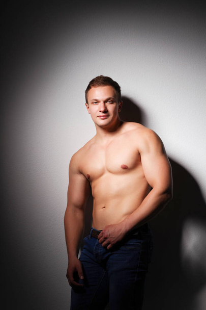 Healthy muscular young man. Isolated on black background - Foto, Imagem