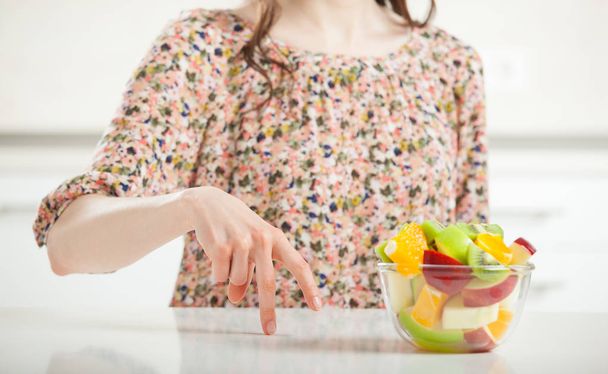 woman moving fingers to salad - Photo, image
