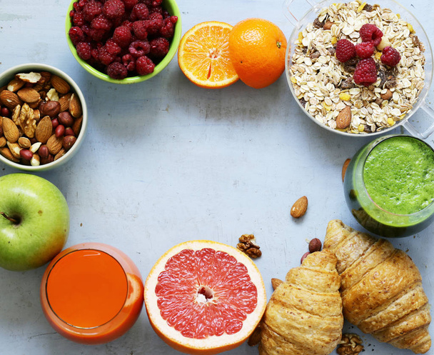 A healthy breakfast with croissants, fresh juice, nuts and raspberries - Photo, Image