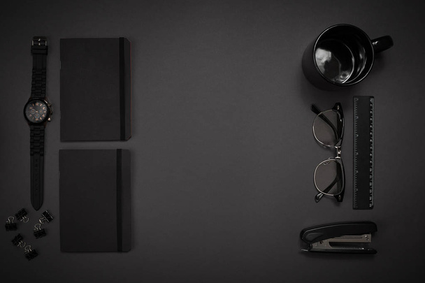 Black objects from the office on a dark gray background. Work an - Zdjęcie, obraz