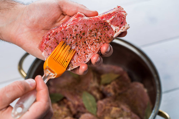 Close up of chefs hands spicing the meat - Photo, Image