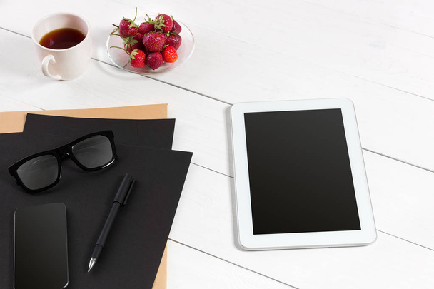 Tablet, blank sheet, glasses and coffee cup on office wooden table - Photo, Image