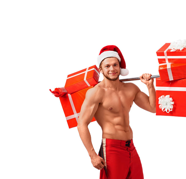 Fit Naked Santa Claus with a barbell full of presents - Фото, изображение