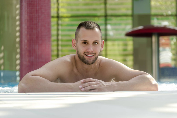 Portrait of handsome man in swimming pool - Fotoğraf, Görsel