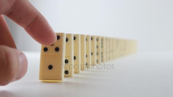 built figure of dominoes falling in slow motion - Footage, Video