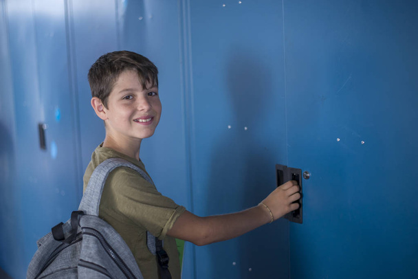 Student and blue school lockers - Zdjęcie, obraz