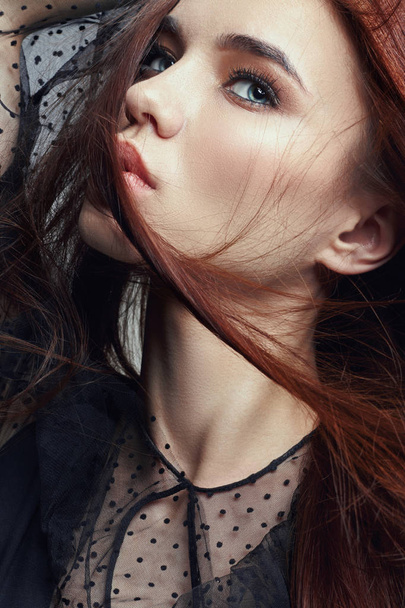 Red hair women are from the wind, the wind blowing in her face. Art fashion portrait of a woman. Clean healthy skin, natural strong hair. - Foto, imagen