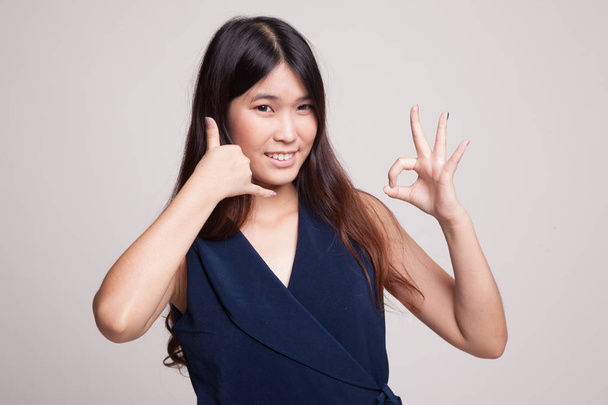 Young Asian woman show with phone gesture and OK sign. - Zdjęcie, obraz