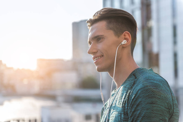 Happy male hearing song in earphones - Фото, зображення