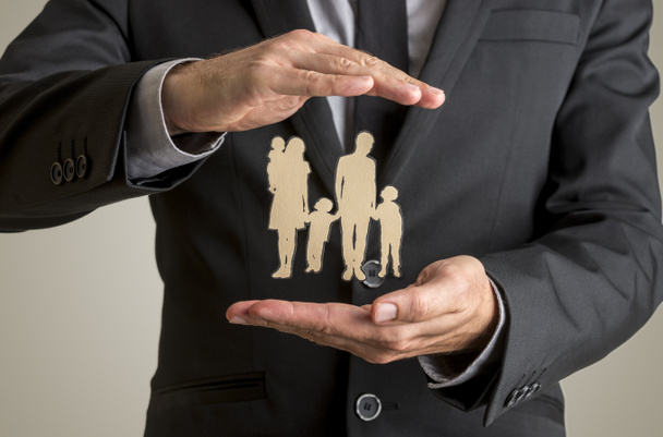 Businessman protecting family silhouette with a father mother ba - Photo, Image