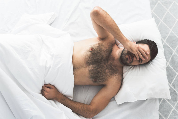 Tired young man waking up early in morning - Valokuva, kuva