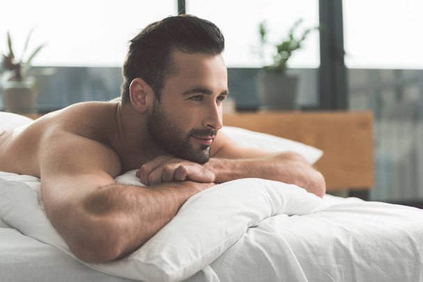 Calm guy dreaming in bedroom - Foto, imagen