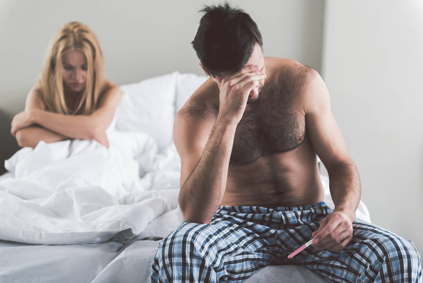 Despaired couple checking results of pregnant test - Φωτογραφία, εικόνα