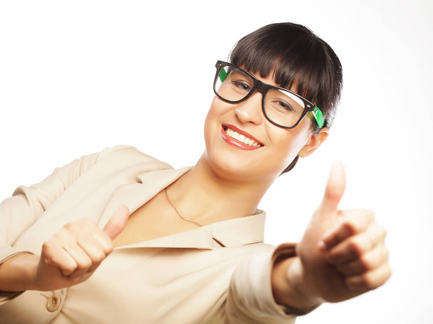 Happy businesswoman showing thumb up over white background - Foto, Imagen