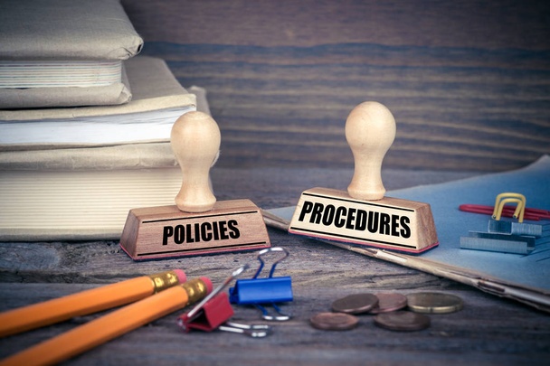 Policies and Procedures concept. Rubber Stamp on desk in the Office. Business and work background - Photo, Image