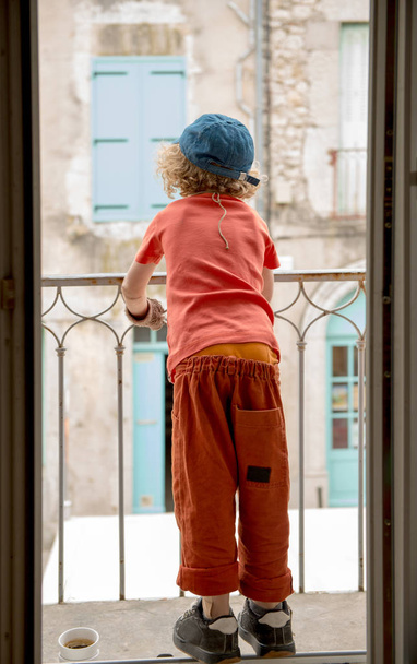 little boy looking out the window, back view - 写真・画像