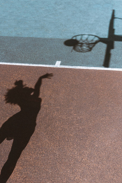 Shadow of woman throwing ball - Photo, Image