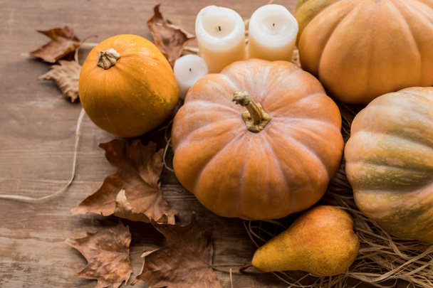 pumpkins and candles on table - Foto, Bild