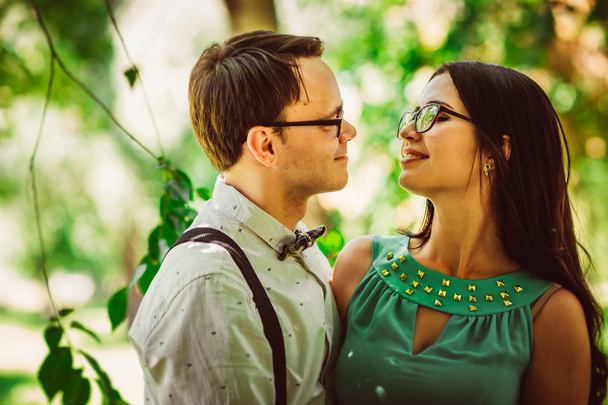 Beautiful young couple on the park background - Foto, Imagen