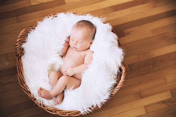Sleeping newborn baby in a wrap on white blanket. - Foto, Imagem