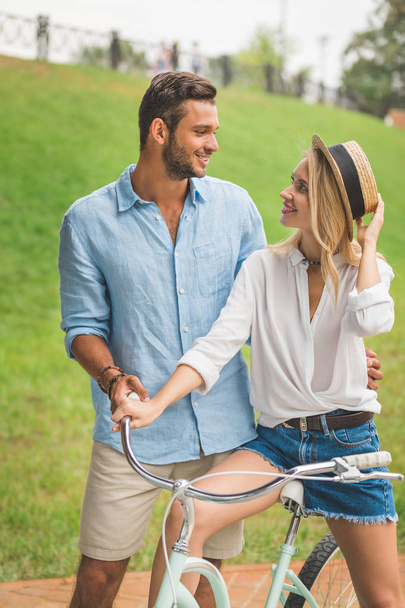smiling couple with bicycle - Photo, Image