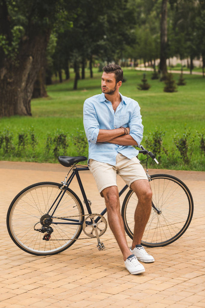 Человек с велосипедом в парке
 - Фото, изображение