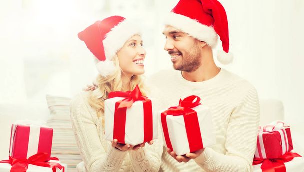 happy couple at home exchanging christmas gifts - Photo, image
